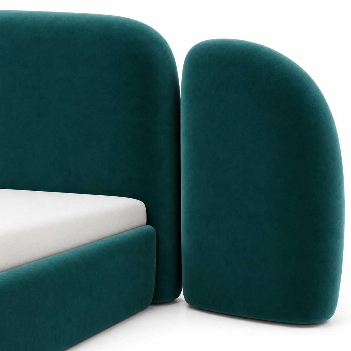 Close view of a rounded side wing beside the central headboard on the teal velvet Vora bed frame