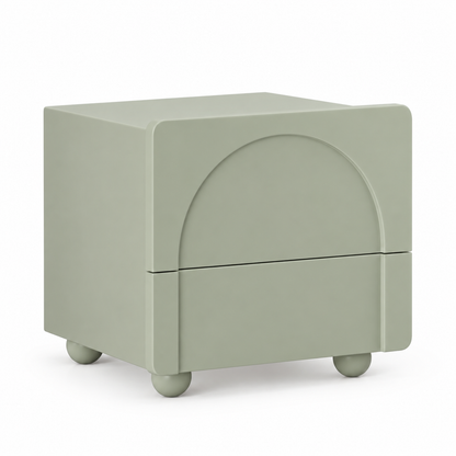 Arwa nightstand in dusty sage green with an arched relief front, two drawers and four spherical feet, three-quarter view