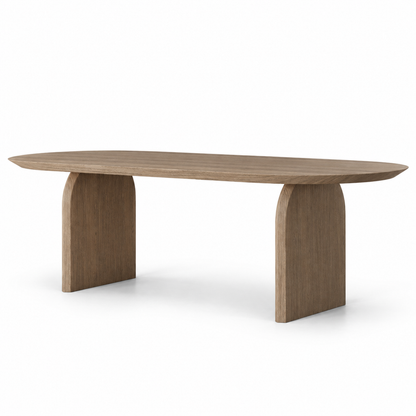 Ardo dining table in smoked oak with a slim oval top on two arched slab legs, three-quarter view

