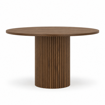 Orso dining table front view showing the round bevelled top and vertical fluted pedestal in walnut
