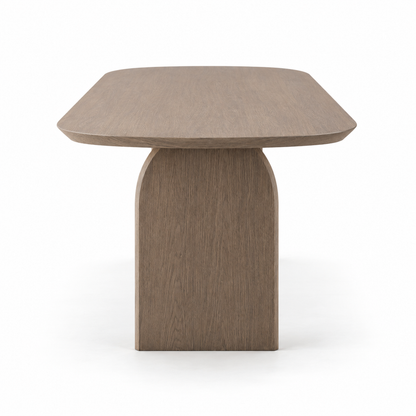 Ardo dining table end view showing the depth and the oval top profile
