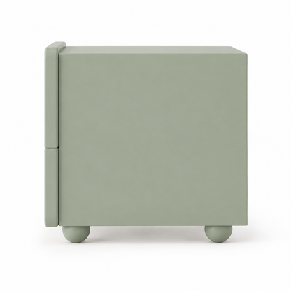 Side profile of the Arwa nightstand showing the rounded front face overhanging the carcass and the spherical feet
