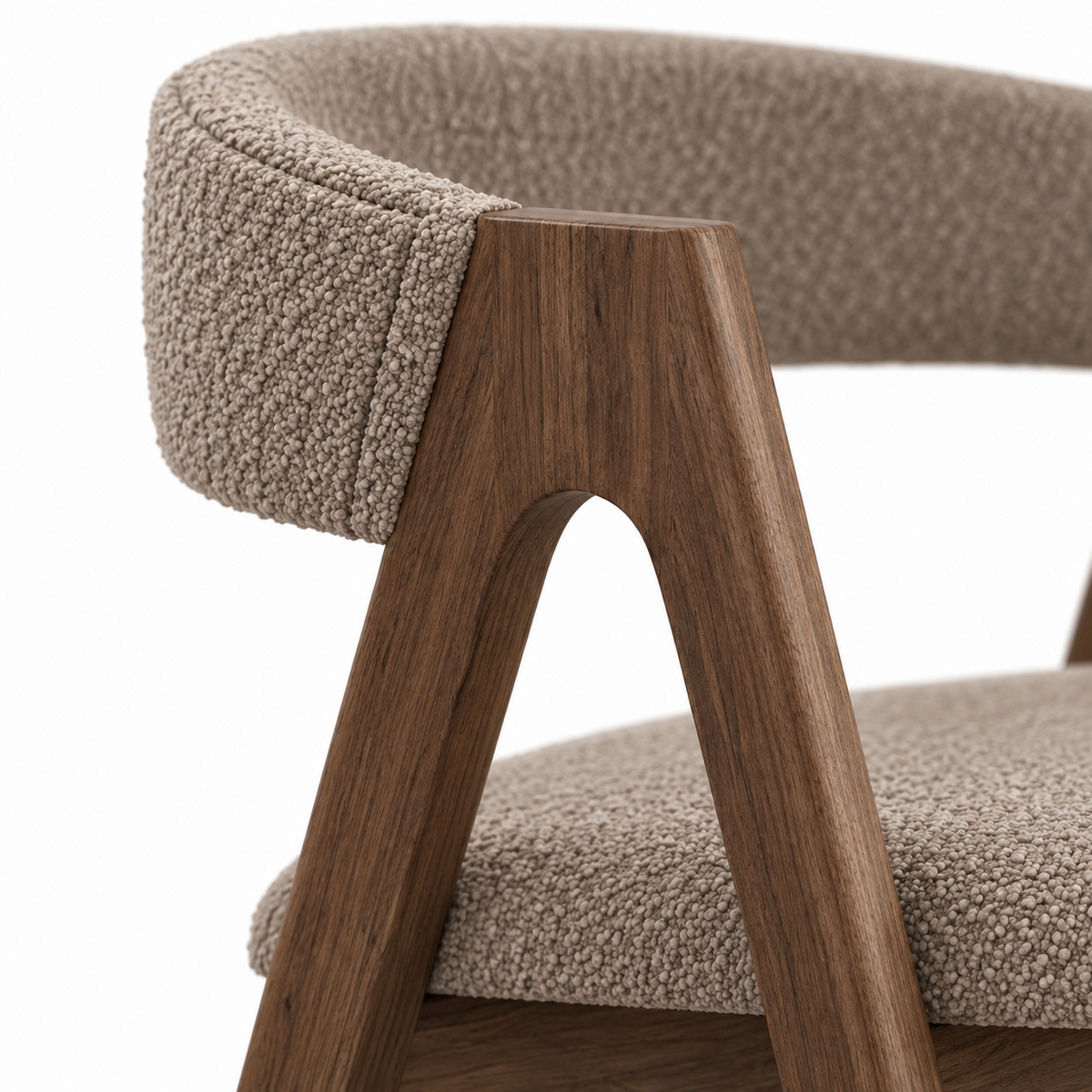 Close-up of mushroom taupe boucle meeting the walnut frame on the Rovo dining chair