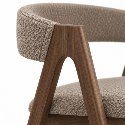 Close-up of mushroom taupe boucle meeting the walnut frame on the Rovo dining chair