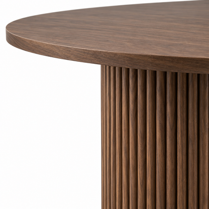 Close-up of the vertical fluting and walnut grain on the Orso dining table pedestal