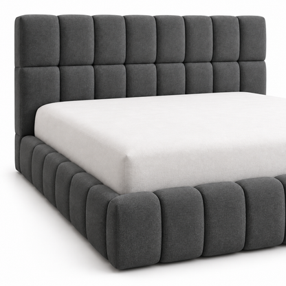 Close view of the square-grid headboard tuft and the horizontal channel footboard tuft on the charcoal Kavo bed frame
