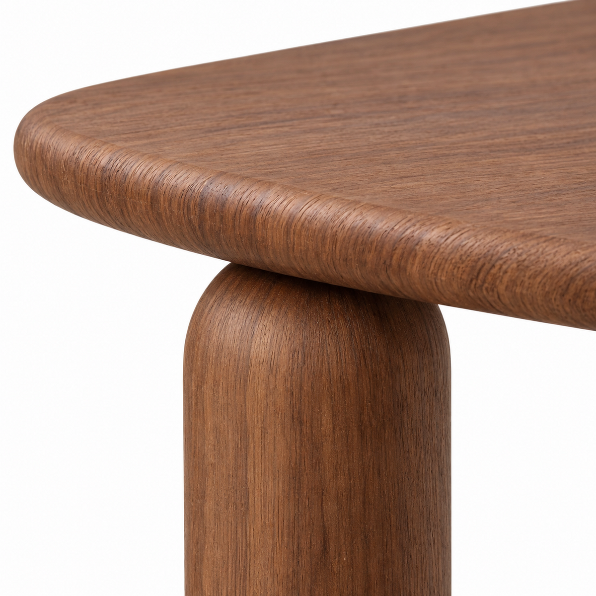 Close-up where the bullnose oval top meets a chunky chestnut capsule leg on the Ruvo dining table