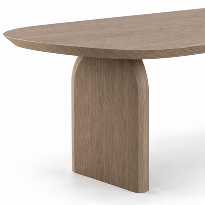 Close-up of smoked oak grain at the knife-edge top and the arched slab leg of the Ardo dining table