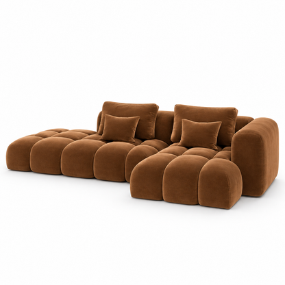 Front view of the cognac Nube modular sofa showing the bubble-tufted seat, back and open chaise platform
