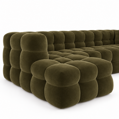 Close view of the bubble-tufted velvet cushions and rounded arm on the Bea sofa
