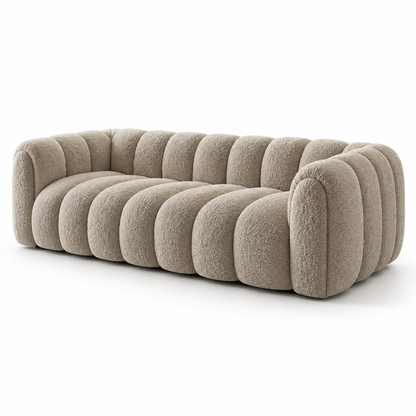 Boucle Sella sofa seen from the opposite angle showing the rounded arms and channelled body
