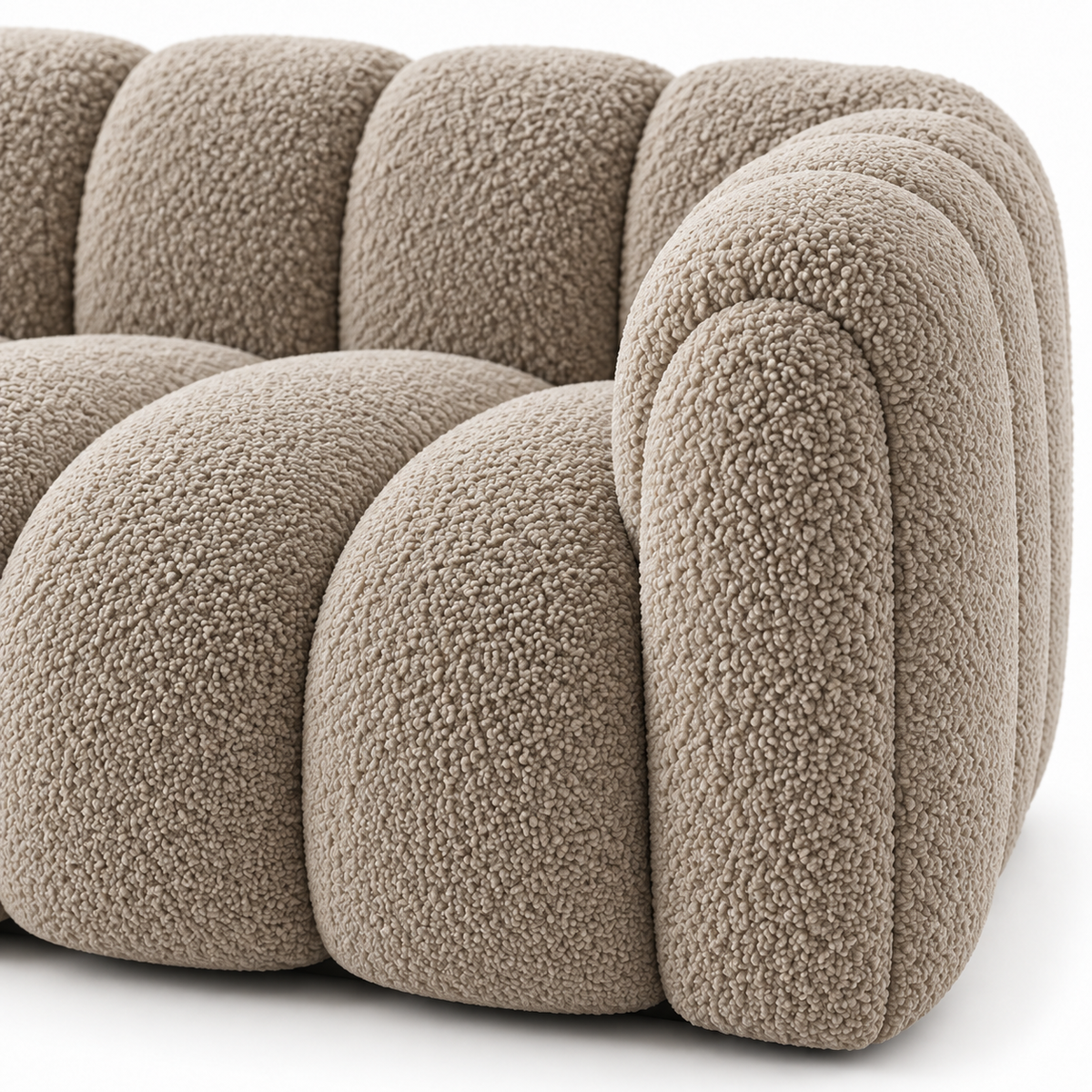 Close view of the deep channels and curly boucle texture on the rounded arm of the Sella sofa
