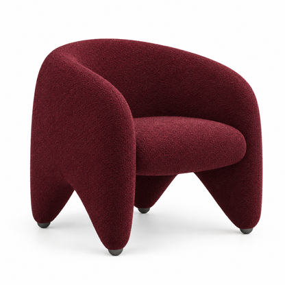 Faye sculptural boucle tub armchair with wrap-around back and tapered legs in deep burgundy, three-quarter view
