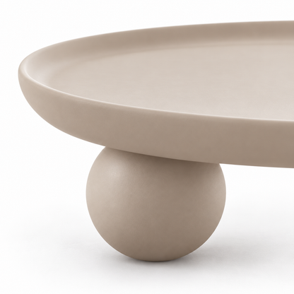 Close-up of the raised rim edge and a spherical ball foot on the Bolo coffee table