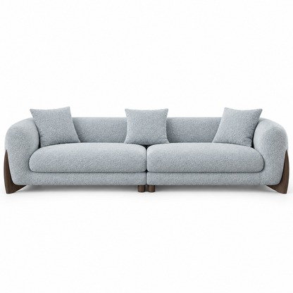 Front view of the grey boucle Covo sofa showing two seat cushions, loose back cushions and the wood base
