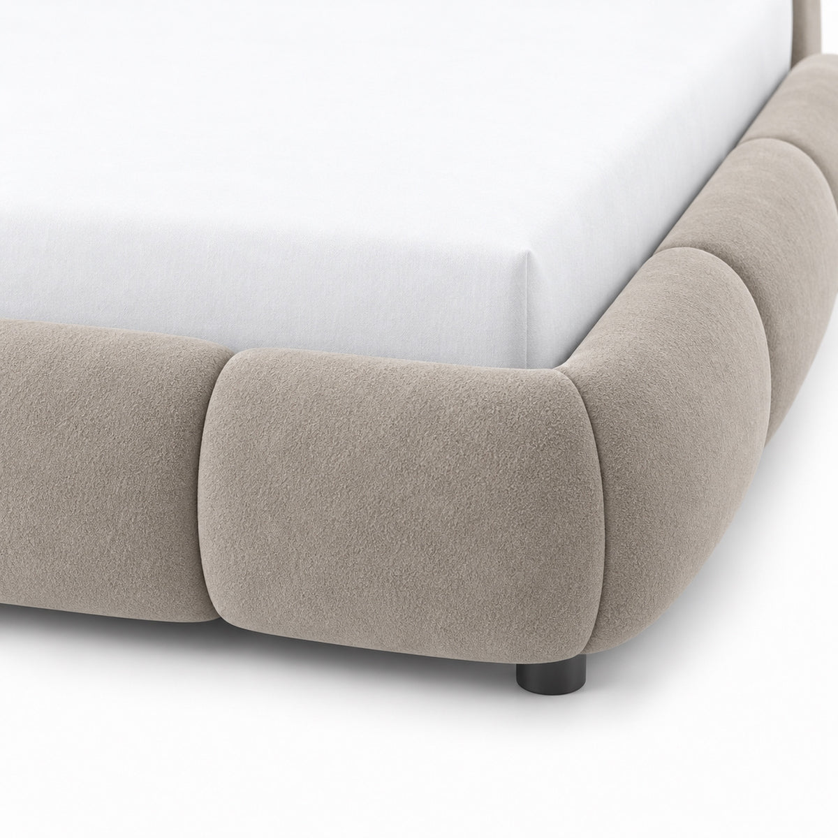 Close-up of Ghaim Cloud Bed channel-style rounded rail surround in soft ivory fabric