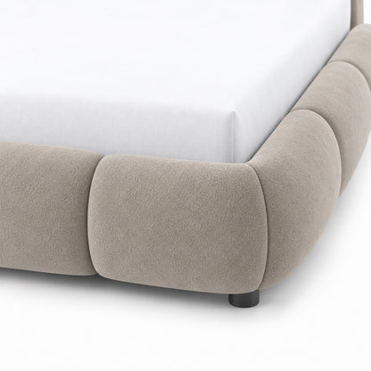 Close-up of Ghaim Cloud Bed channel-style rounded rail surround in soft ivory fabric