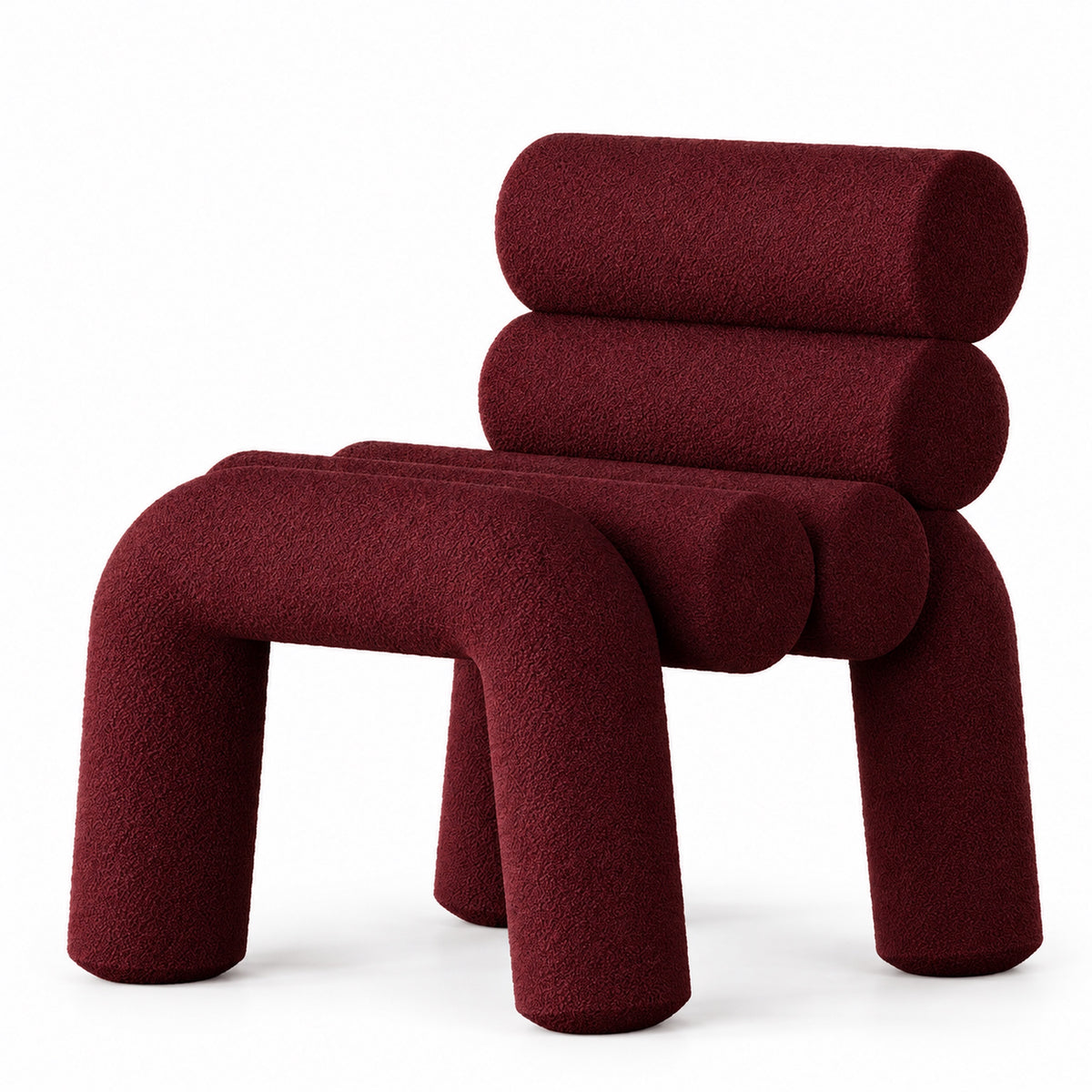 Juno sculptural tube Accent Chair with stacked bolster back and arched legs in deep burgundy boucle, three-quarter view
