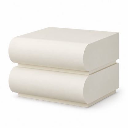 Layl two-drawer nightstand with rounded scroll fronts in matt off-white, three-quarter view