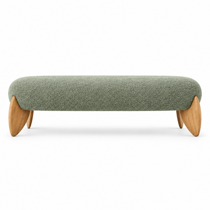 Vela bench front view showing the rounded capsule seat and flat leaf-shaped oak legs in sage green boucle