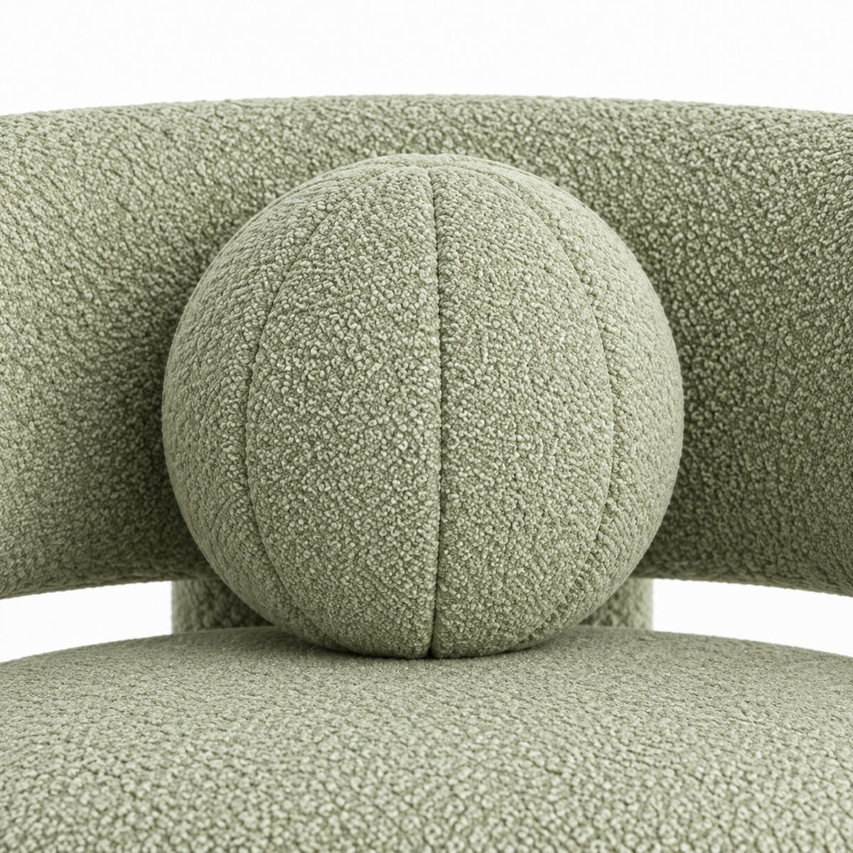 Close-up of Pomo armchair round toss pillow showing segmented stitching and boucle texture
