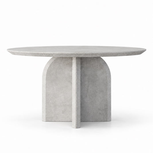 Qamar round dining table front view showing sculptural cross pedestal base
