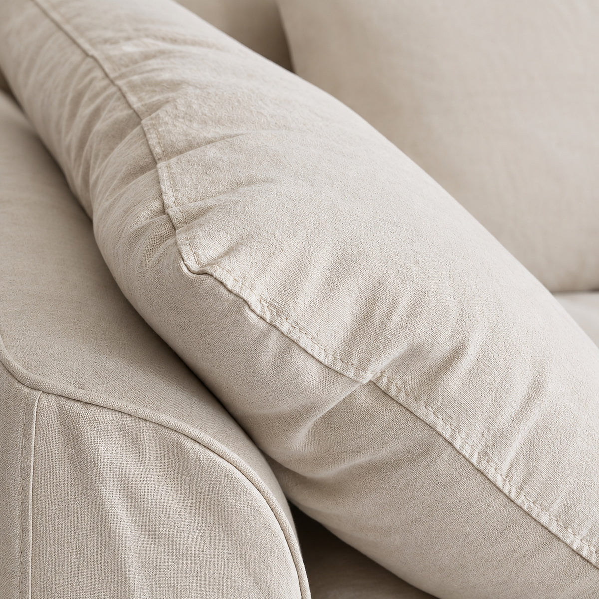 Close-up of Raha sofa cushion seam and soft linen-cotton fabric texture