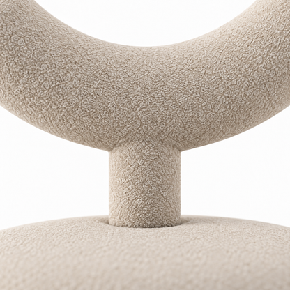 Close-up of Taso accent chair sand boucle texture where the backrest meets its stem
