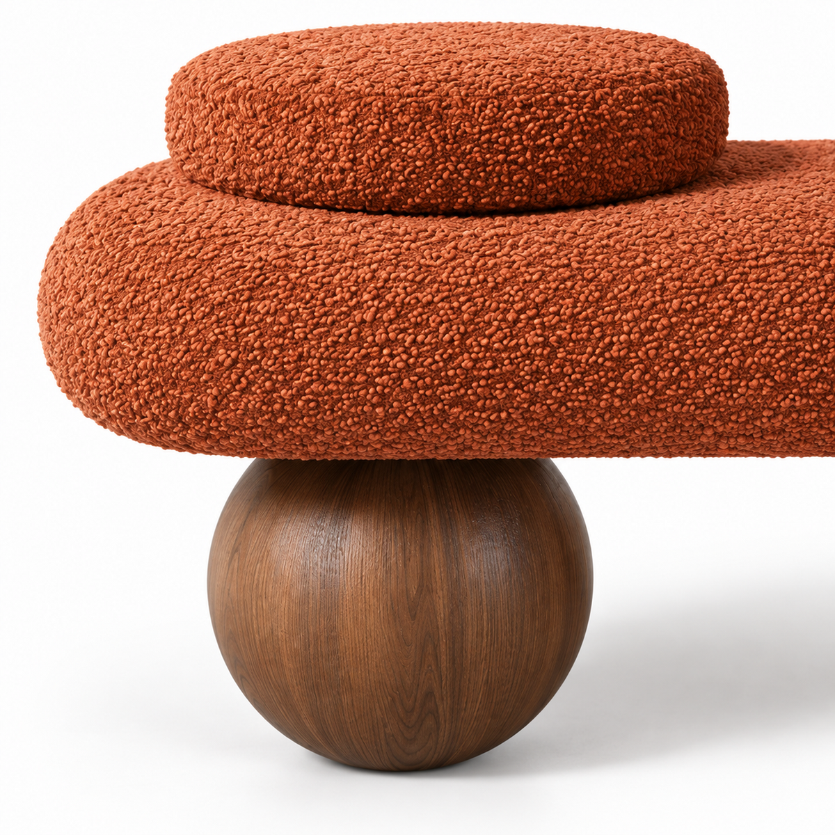 Close-up of terracotta boucle texture meeting the walnut ball foot on the Kura bench