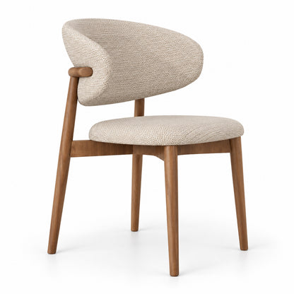 Vela dining chair with curved shell back in beige linen on a walnut wood frame, three-quarter view
