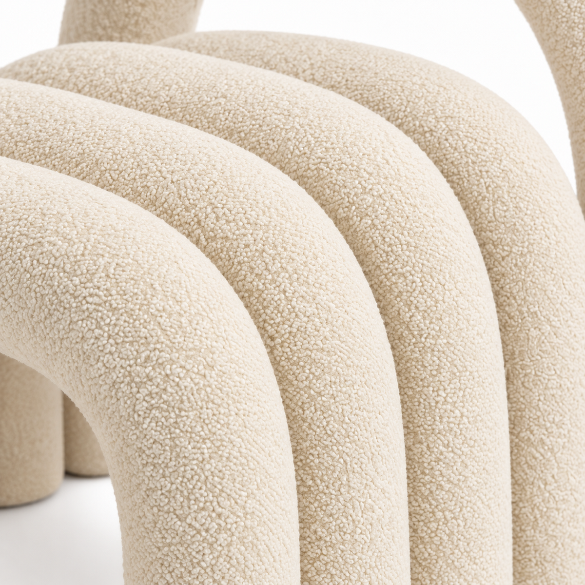 Close-up of Loop accent chair cream velvet texture on the nested arch tubes
