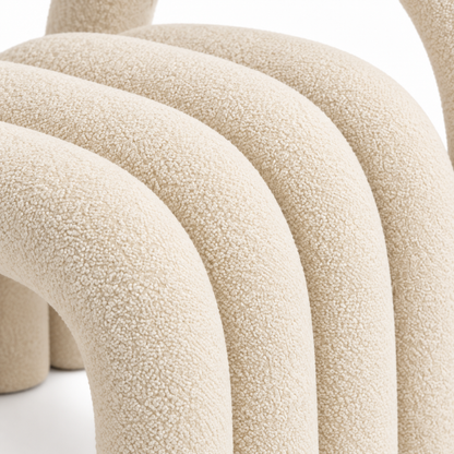 Close-up of Loop accent chair cream velvet texture on the nested arch tubes
